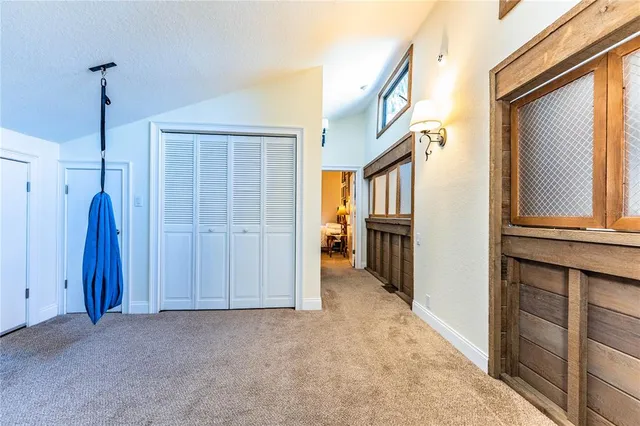 an aerial view of residential houses with outdoor space and trees