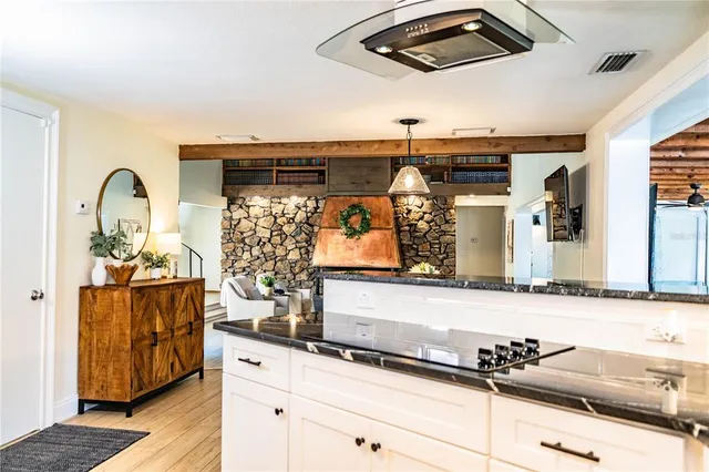 a kitchen with stainless steel appliances granite countertop a refrigerator a sink and a stove