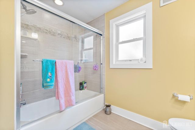 a bathroom with a bathtub and shower