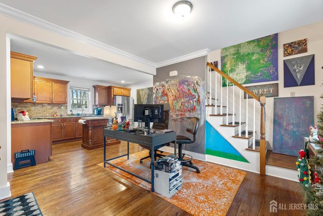 a living room with furniture and a open kitchen view