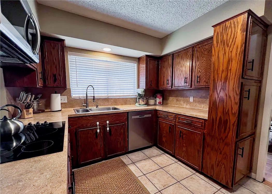 418 Seco Drive Portland, TX 78374 - Photo 11 of 32 a kitchen with stainless steel appliances granite countertop a sink stove and refrigerator