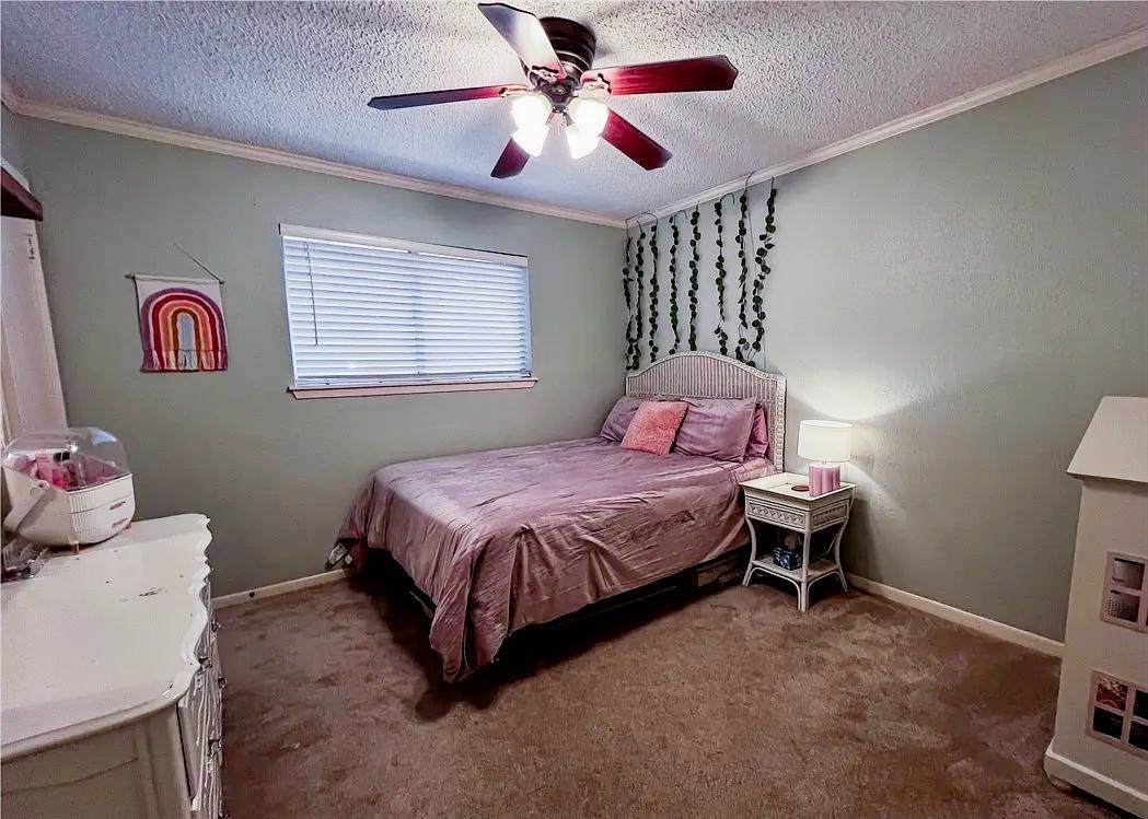 418 Seco Drive Portland, TX 78374 - Photo 20 of 32 a bedroom with a bed and a chandelier