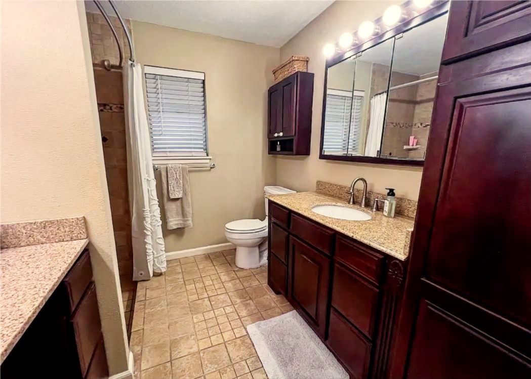 418 Seco Drive Portland, TX 78374 - Photo 26 of 32 a bathroom with a granite countertop sink toilet and shower