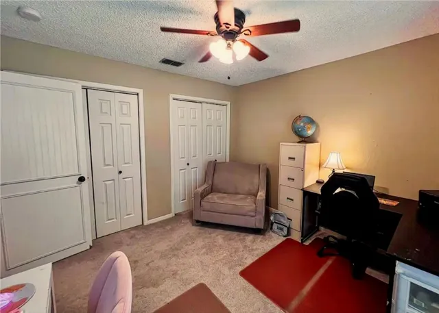 a living room with furniture and a air conditioner vent