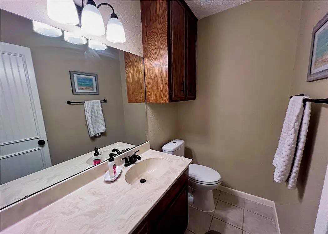 418 Seco Drive Portland, TX 78374 - Photo 3 of 32 a bathroom with a sink a toilet and a mirror