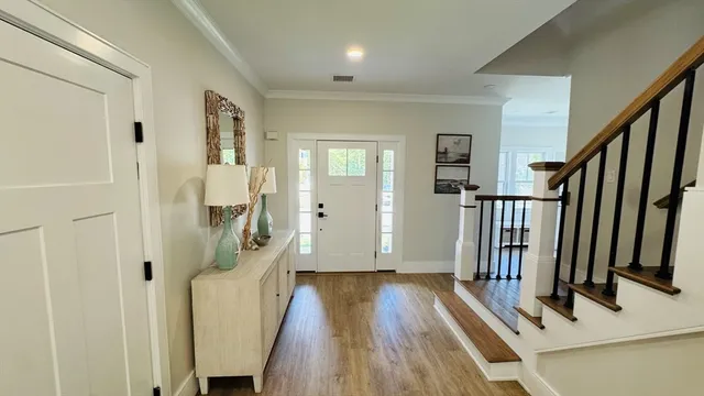 a living room with a large window and wooden floor