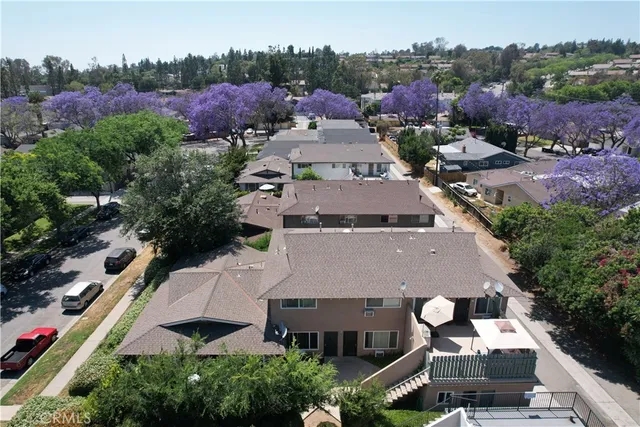 an aerial view of multiple houses with a yard