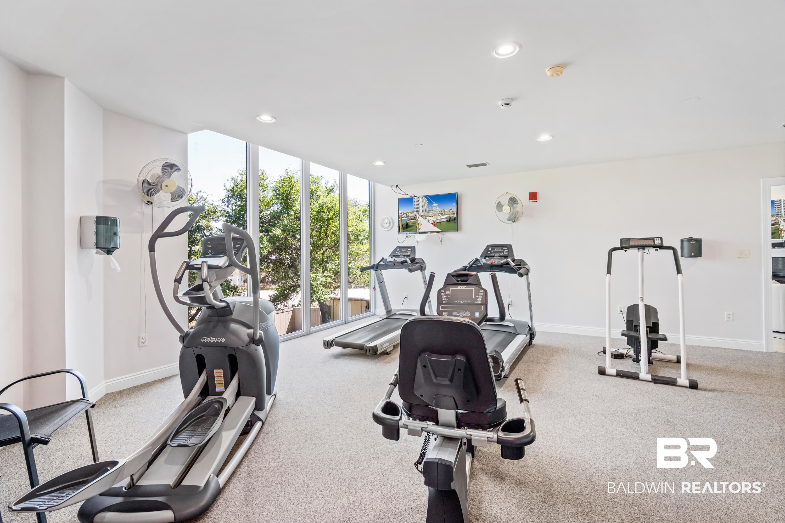 28250 Canal Road, Unit 101 Orange Beach, AL 36561 - Photo 29 of 34 Exercise room featuring recessed lighting, floor to ceiling windows, and baseboards