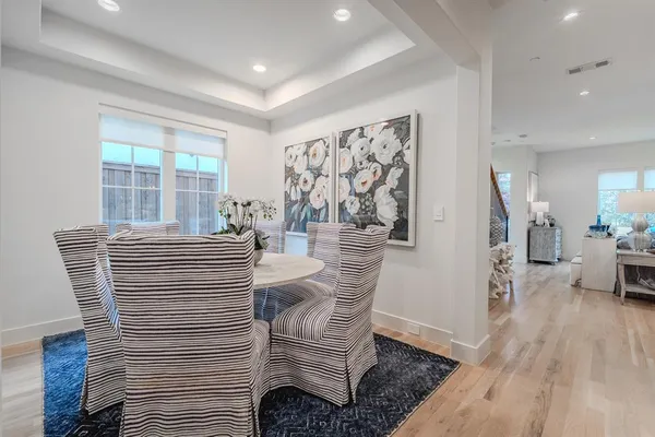 a view of a dining room with furniture and wooden floor