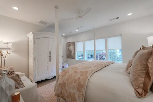 a large bedroom with a bed and a large window