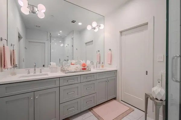 a bathroom with a sink vanity and a mirror