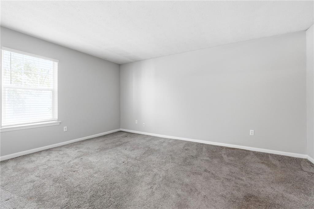 1150 Collier Road Northwest, Unit 4C Atlanta, GA 30318 - Photo 12 of 27 an empty room with a window