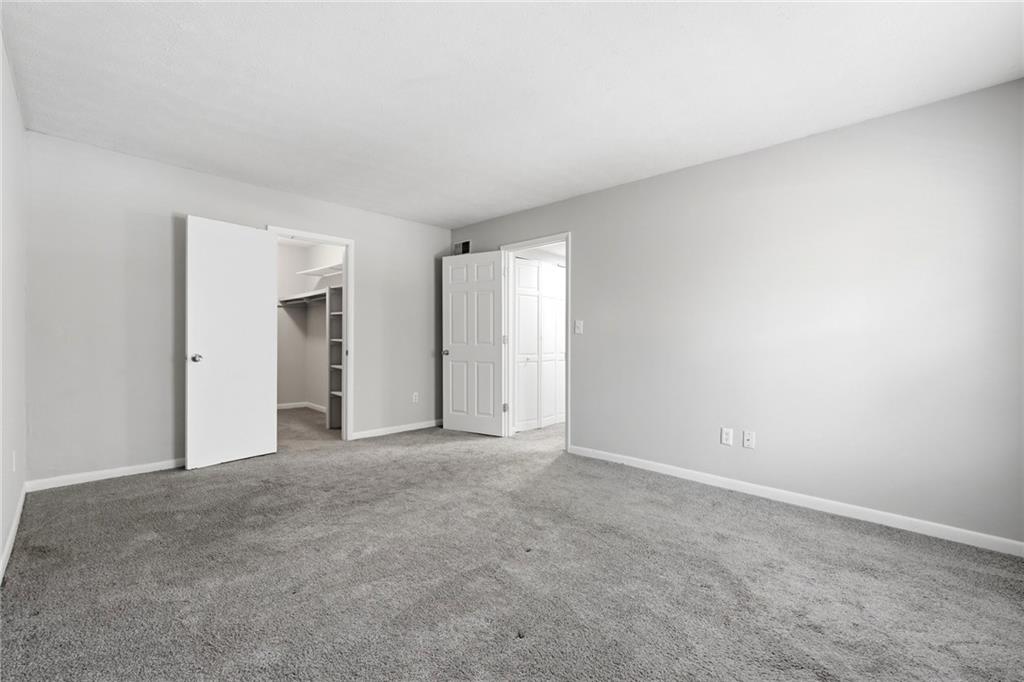 1150 Collier Road Northwest, Unit 4C Atlanta, GA 30318 - Photo 13 of 27 a view of an empty room with closet and a window
