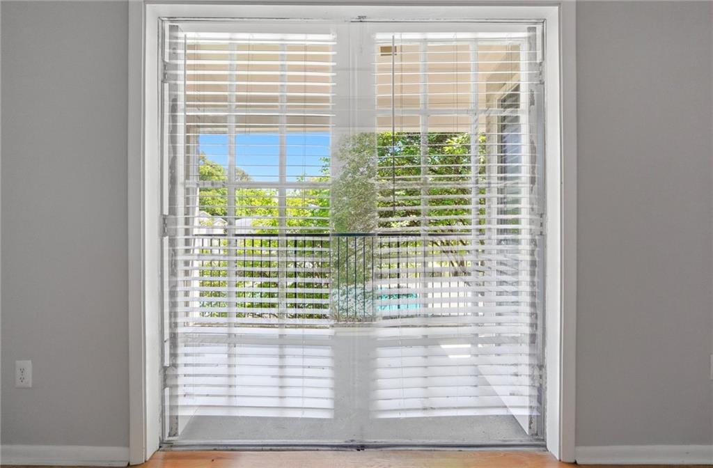 1150 Collier Road Northwest, Unit 4C Atlanta, GA 30318 - Photo 16 of 27 a view of a glass door and red door