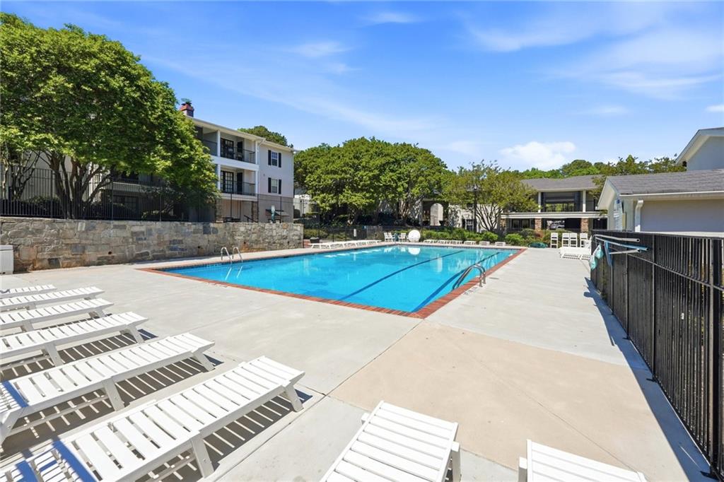 1150 Collier Road Northwest, Unit 4C Atlanta, GA 30318 - Photo 25 of 27 a view of a swimming pool with a lounge chairs