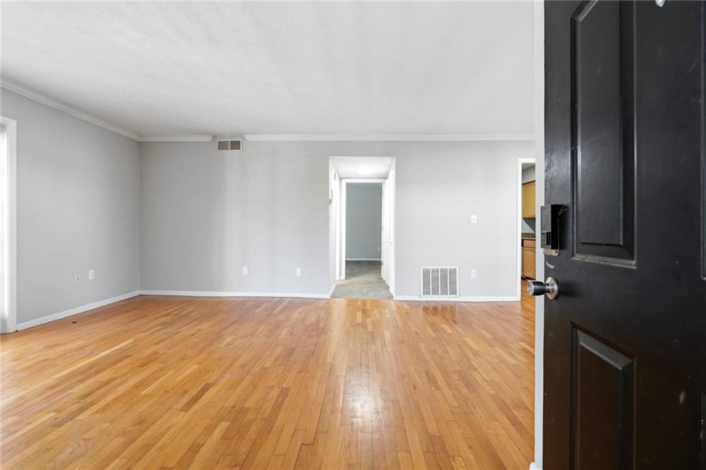 1150 Collier Road Northwest, Unit 4C Atlanta, GA 30318 - Photo 4 of 27 a view of empty room with wooden floor