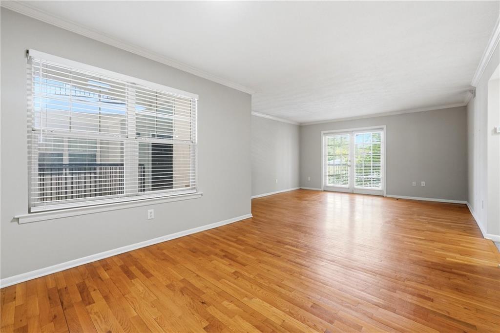 1150 Collier Road Northwest, Unit 4C Atlanta, GA 30318 - Photo 7 of 27 a view of empty room with wooden floor and fan