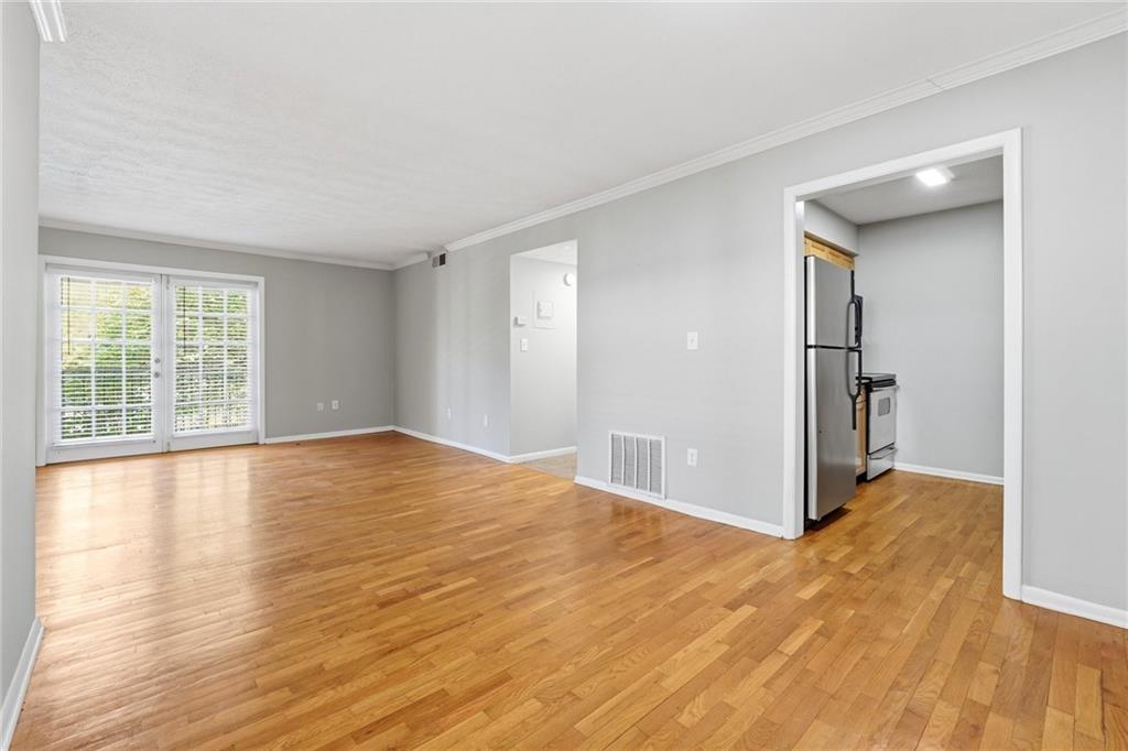 1150 Collier Road Northwest, Unit 4C Atlanta, GA 30318 - Photo 8 of 27 a view of empty room with wooden floor and fan