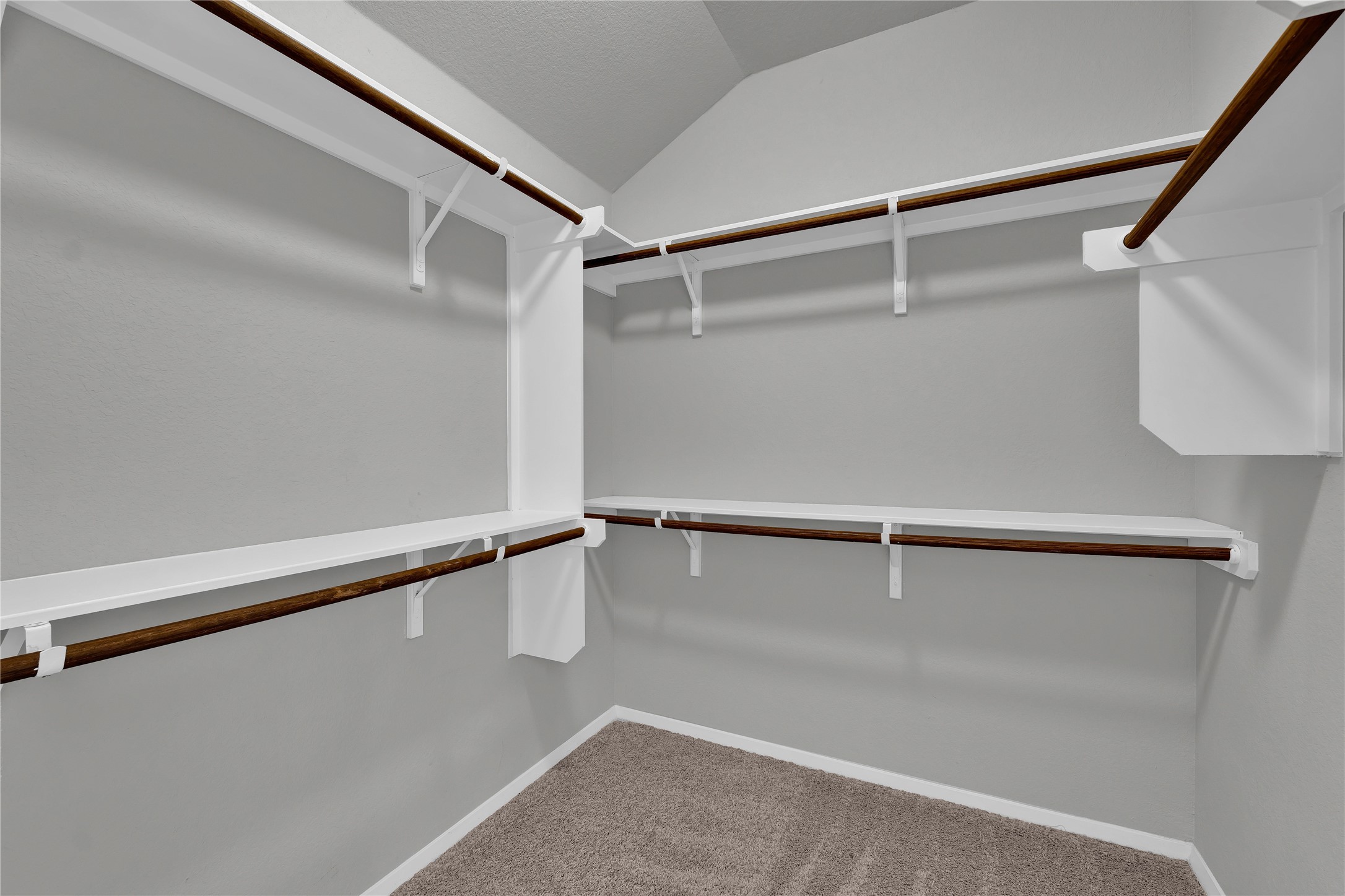 101 Crescent Street Georgetown, TX 78626 - Photo 21 of 39 Primary walk-in closet featuring ample shelving and hanging space, perfect for storage.