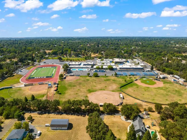 an aerial view of residential houses with outdoor space