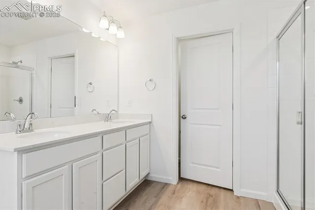 a bathroom with a double vanity sink and a mirror