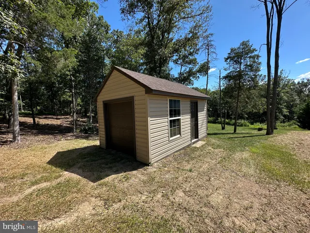 a view of a kitchen with a stove wooden floor and a kitchen