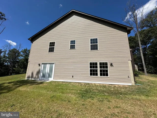 a bathroom with a toilet and a mirror