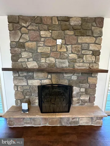 a bathroom with a granite countertop tub sink and mirror