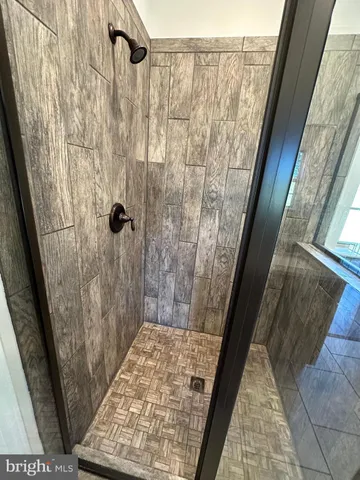 a view of an empty room with wooden ceiling