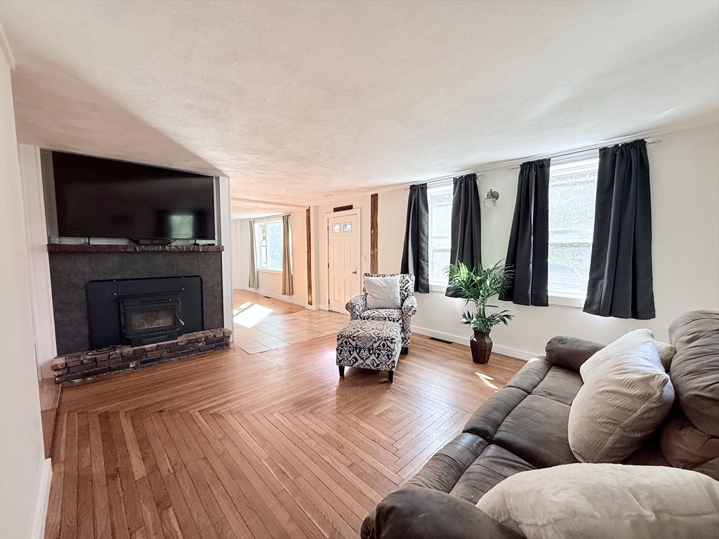 975 South Main Street Bellingham, MA 02019 - Photo 5 of 38 a living room with furniture fireplace and flat screen tv