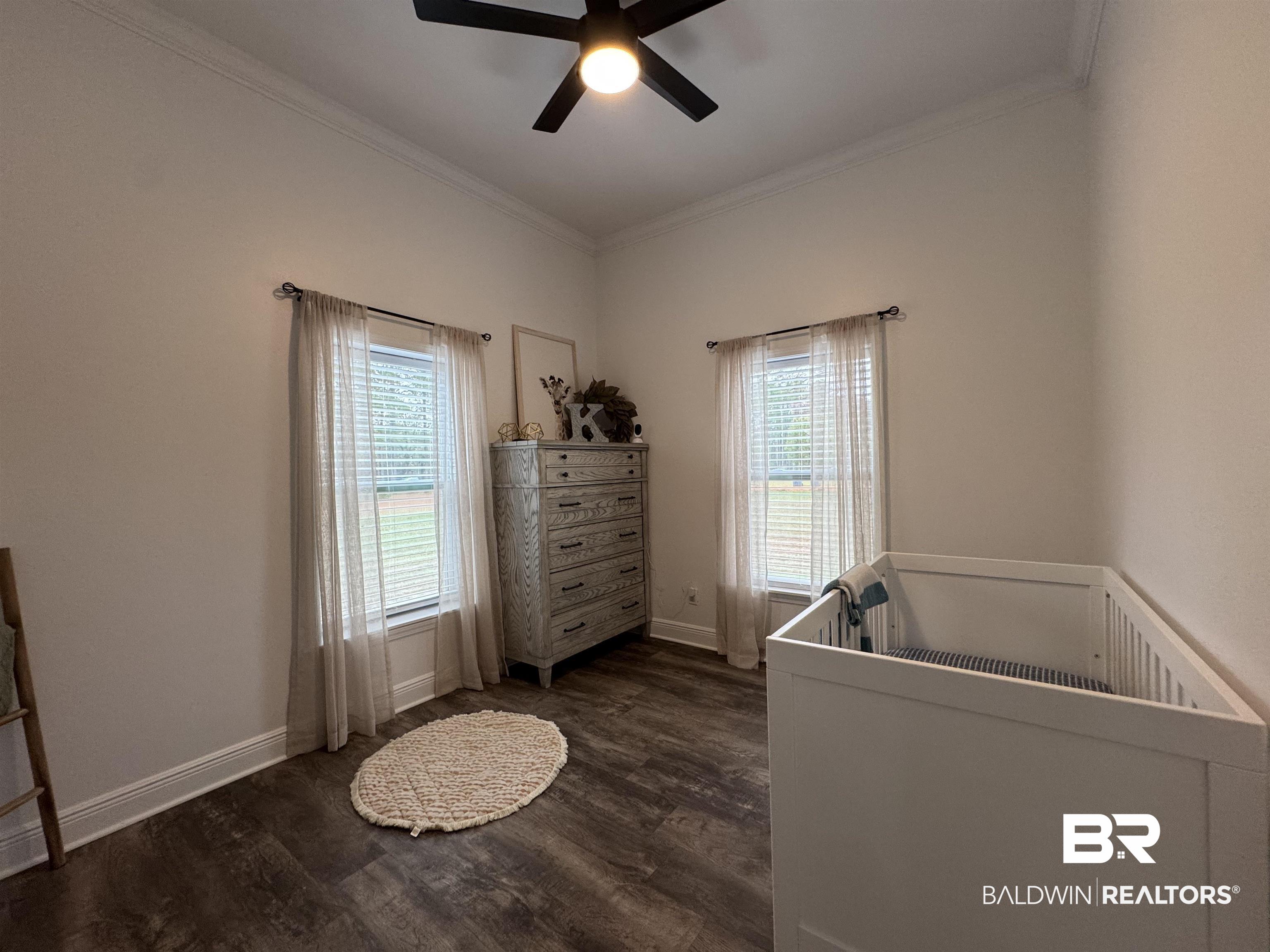370 Dianne Road Frisco City, AL 36445 - Photo 21 of 41 Bedroom featuring dark hardwood / wood-style flooring, multiple windows, ceiling fan, and a crib