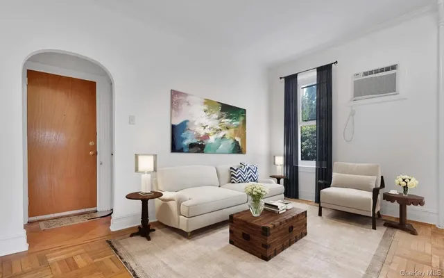 a living room with furniture and a painting on the wall
