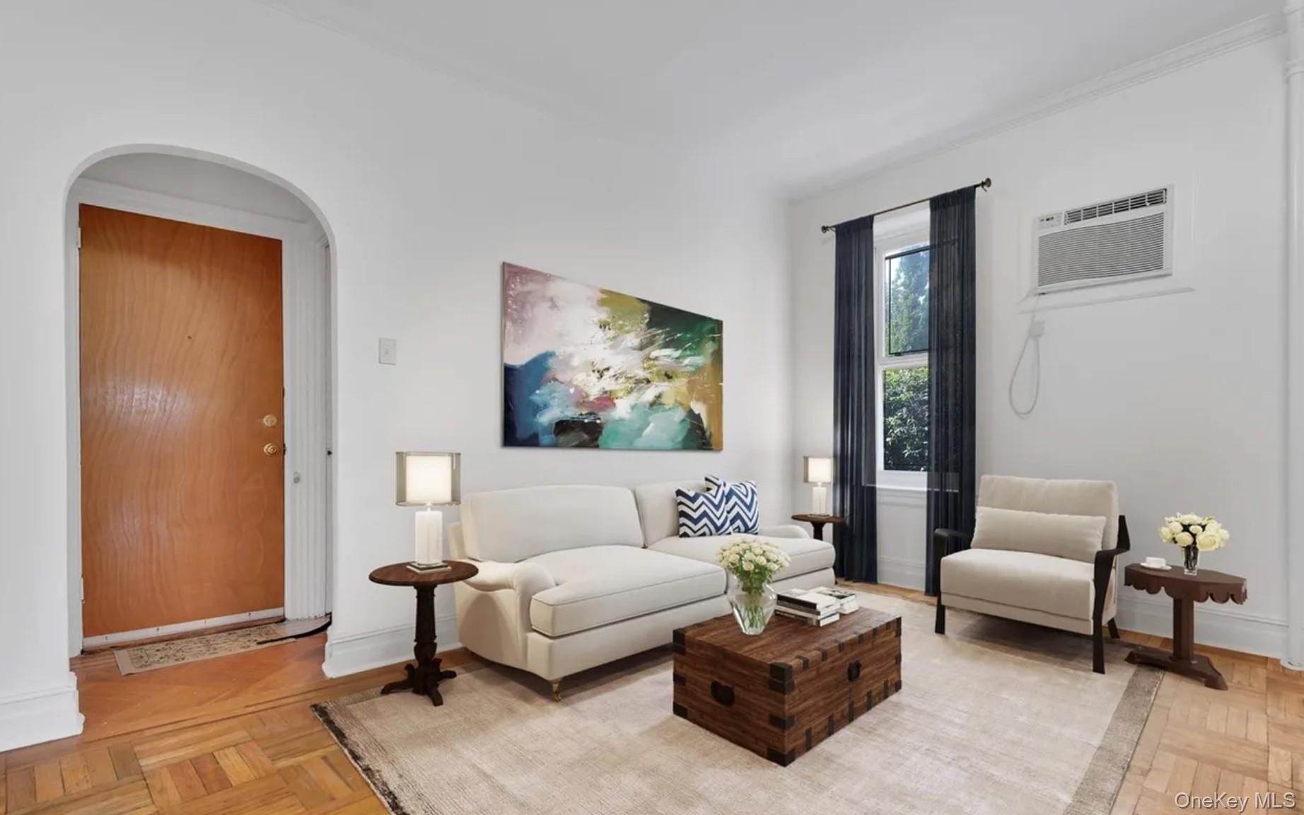 a living room with furniture and a painting on the wall