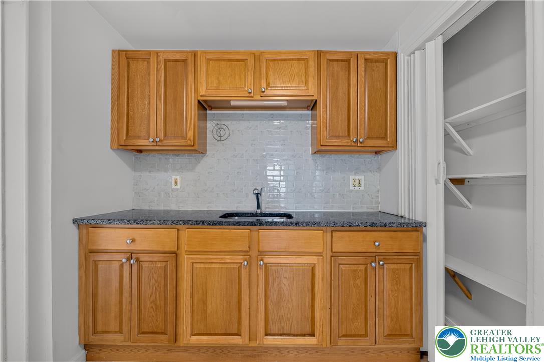 313 Main Street Slatington, PA 18080 - Photo 30 of 73 Functional kitchen offers ample storage with rich wooden cabinetry and polished countertops.