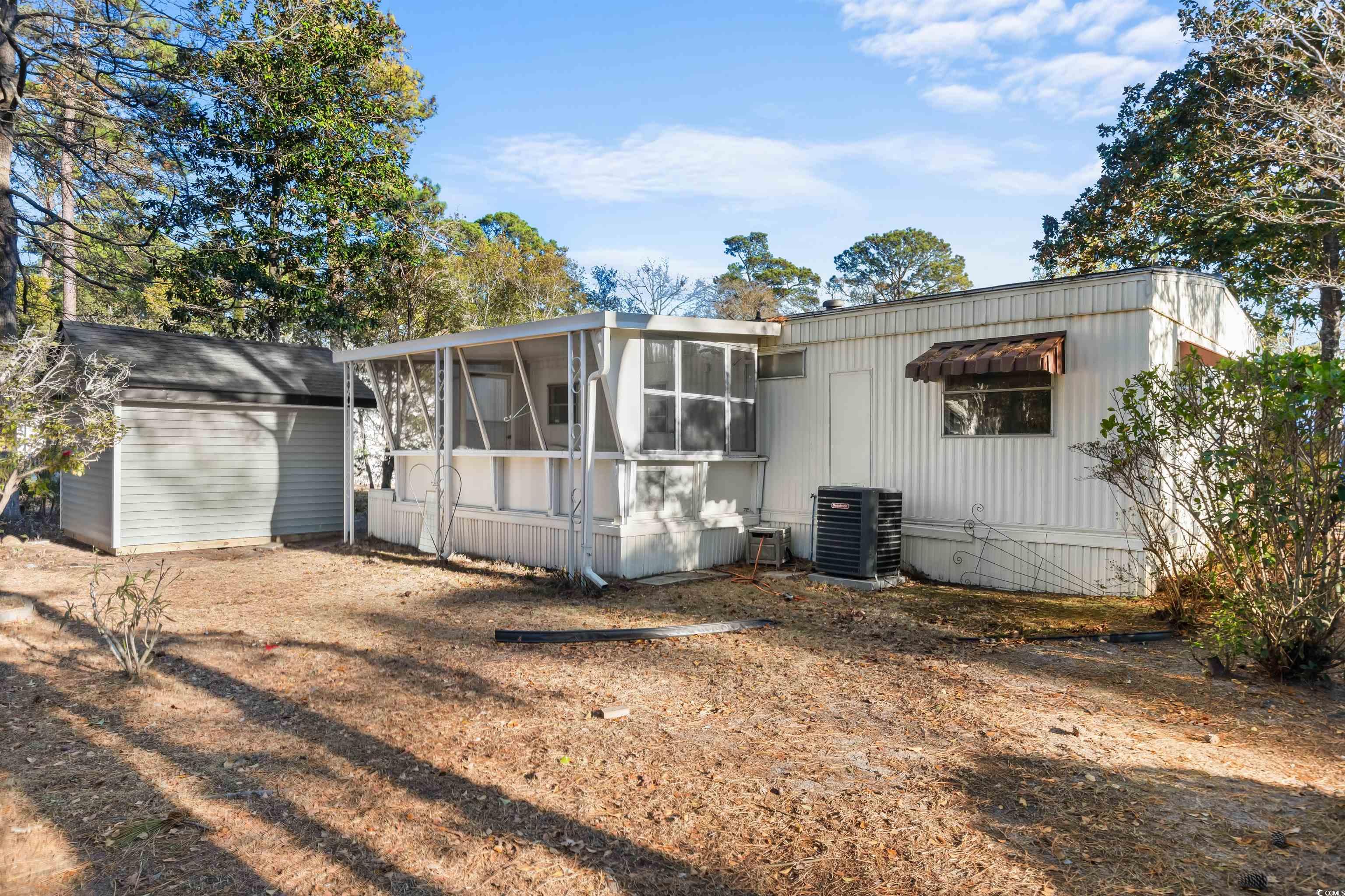 2950 Clemson Trail Murrells Inlet, SC 29576 - Photo 25 of 29 Rear view of house with a sunroom, central AC unit