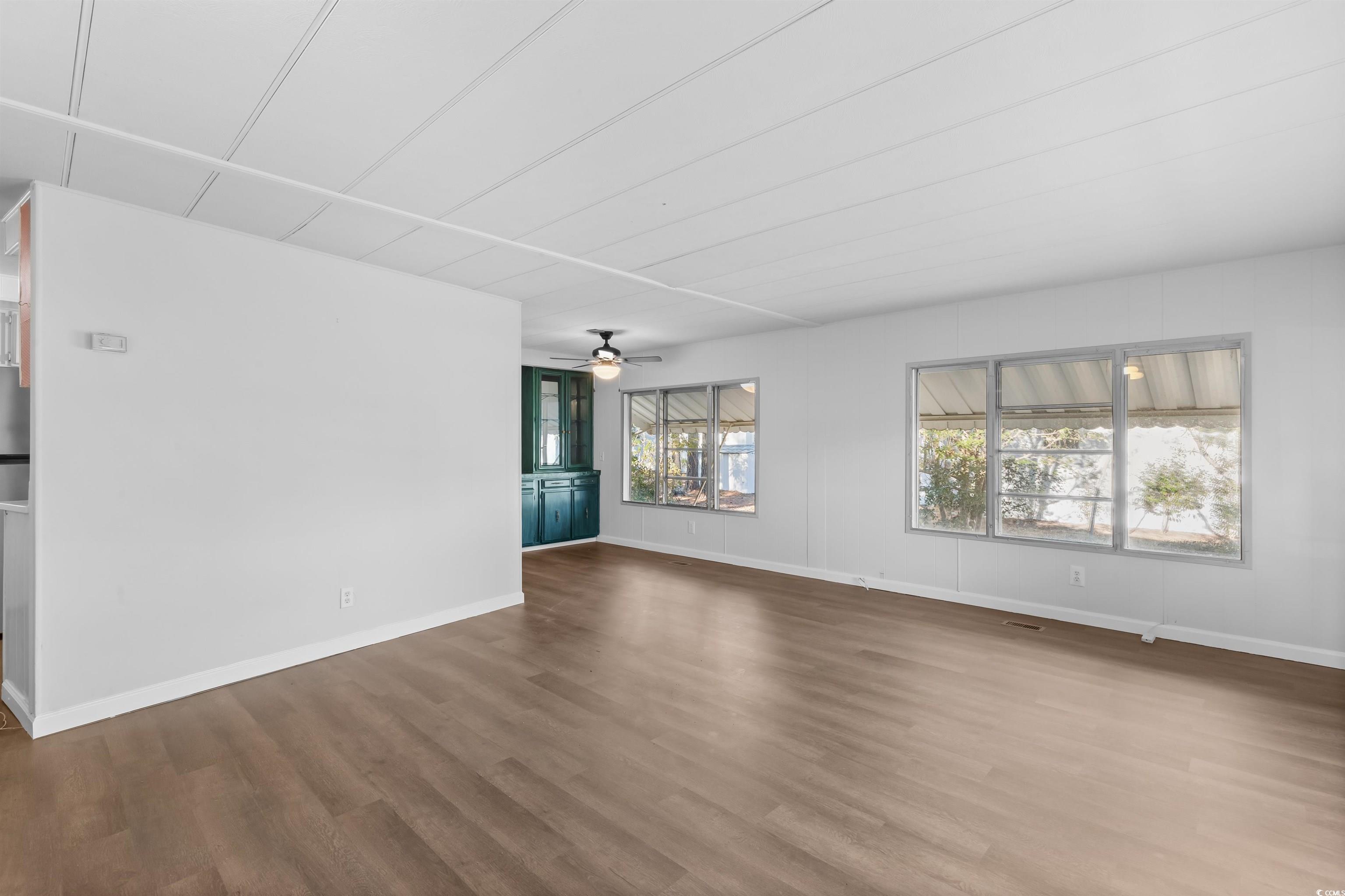 2950 Clemson Trail Murrells Inlet, SC 29576 - Photo 3 of 29 Unfurnished living room with hardwood / wood-style