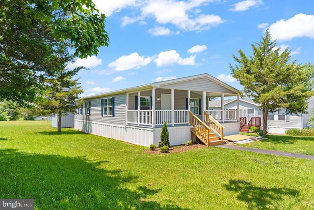 a view of a house with a yard and sitting area