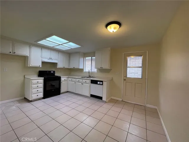 a kitchen with stainless steel appliances granite countertop a sink and cabinets