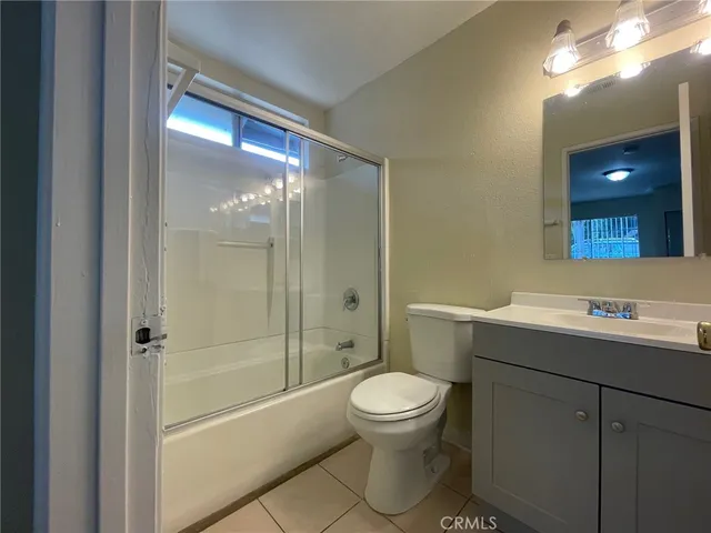 a bathroom with a toilet a sink and shower