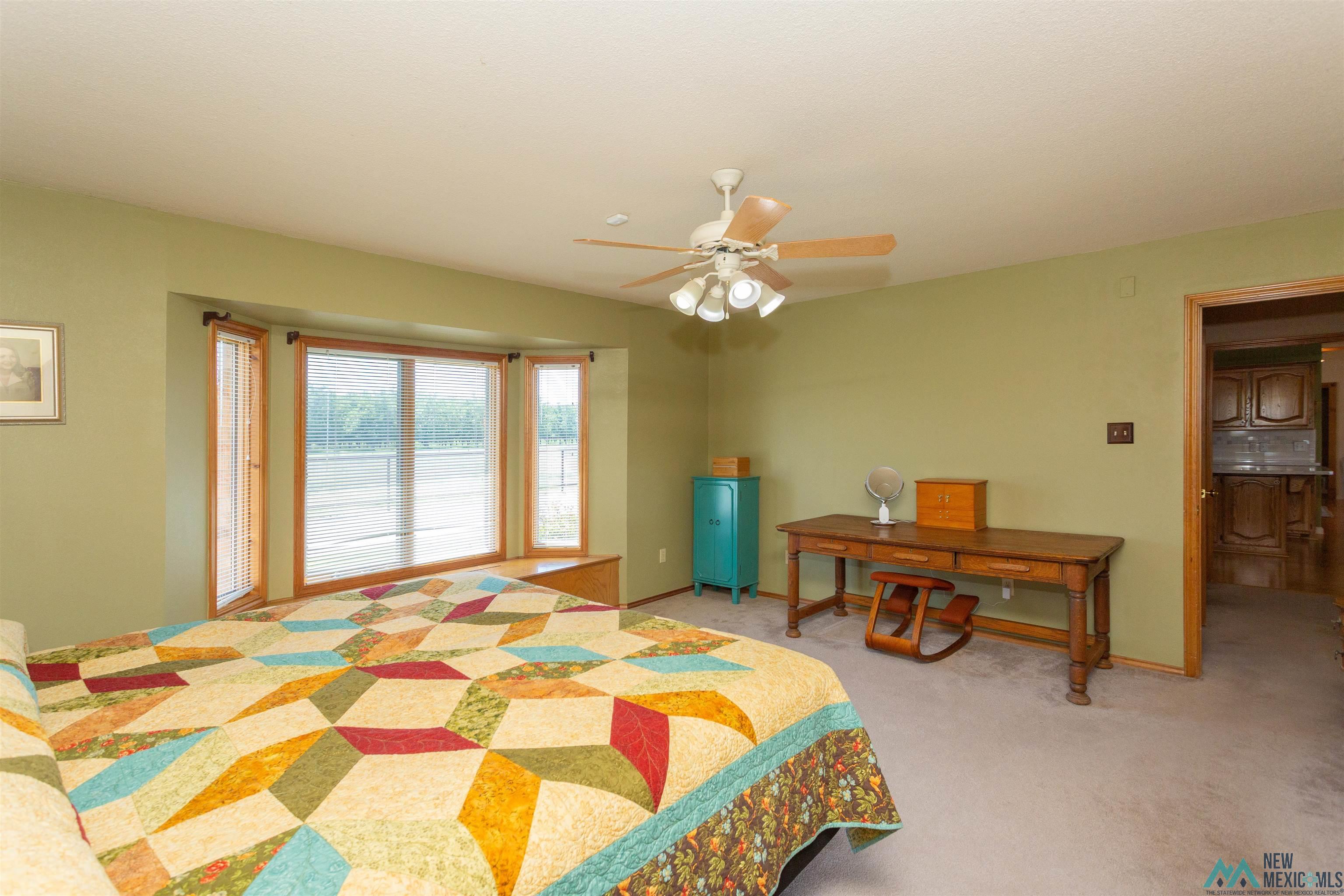 2012 South Haldeman Road Artesia, NM 88210 - Photo 48 of 96 Spacious room featuring a multi-pane bay window with an integrated window seat, light green walls, and carpet flooring