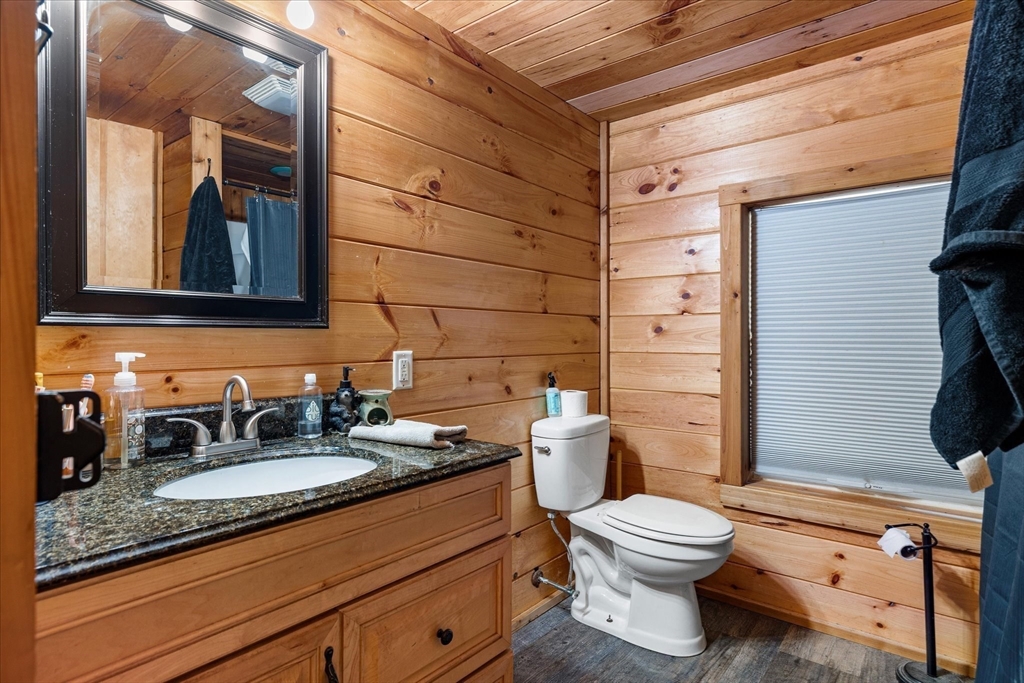 8 Oakwood Road Brimfield, MA 01010 - Photo 16 of 34 a bathroom with a granite countertop toilet a sink and a mirror