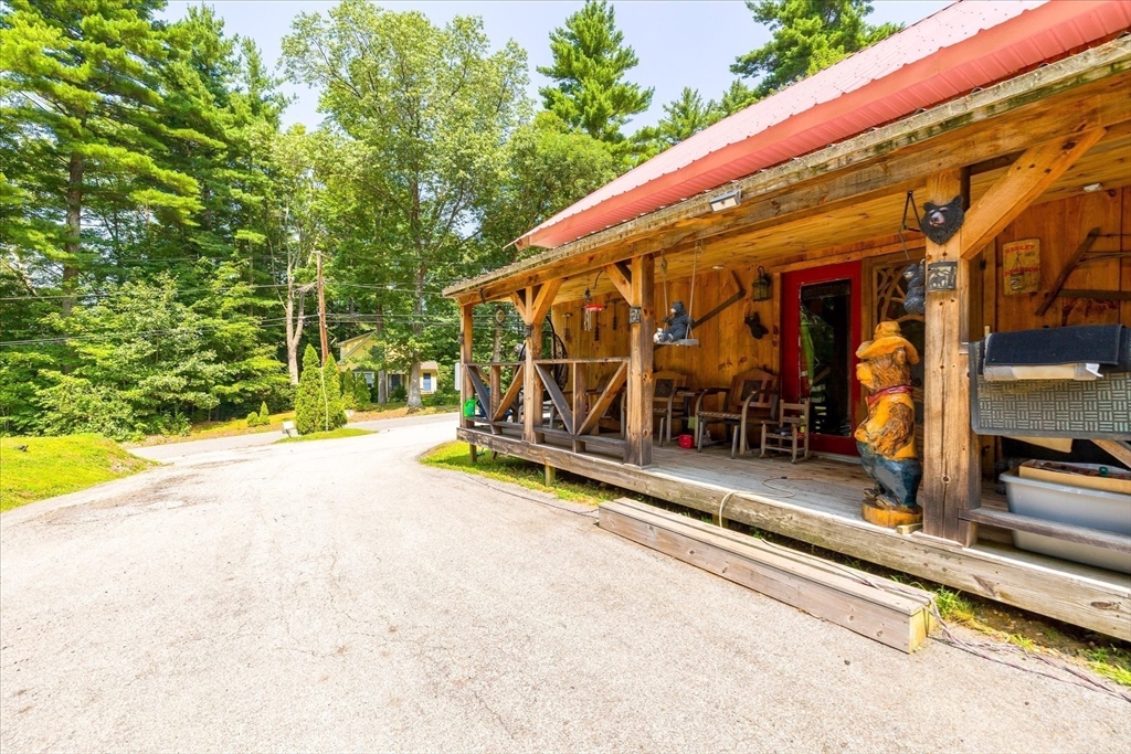 8 Oakwood Road Brimfield, MA 01010 - Photo 2 of 34 a view of a patio with a table and chairs under an umbrella