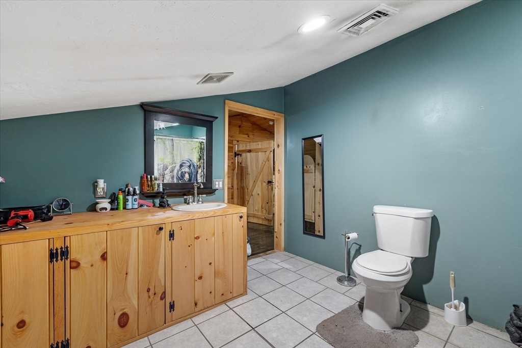 8 Oakwood Road Brimfield, MA 01010 - Photo 22 of 34 a bathroom with a toilet a sink and mirror