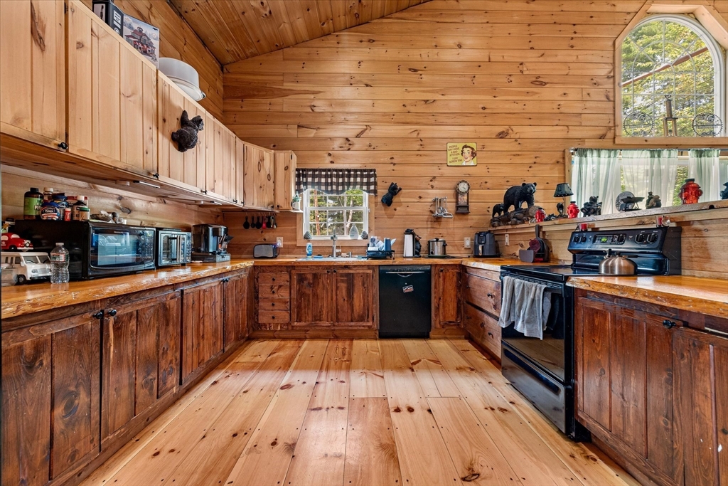 8 Oakwood Road Brimfield, MA 01010 - Photo 5 of 34 a kitchen with stainless steel appliances wooden floors wooden cabinets a sink and a stove