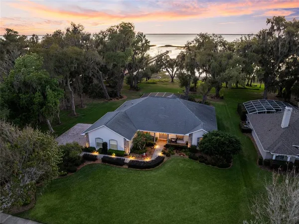 an aerial view of a house with garden space and street view