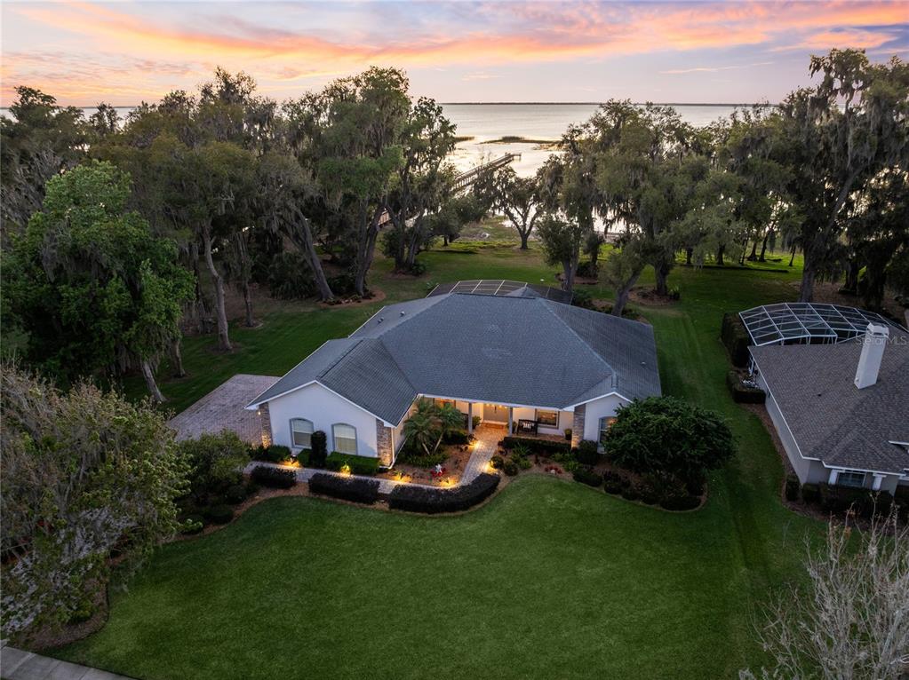 an aerial view of a house with garden space and street view