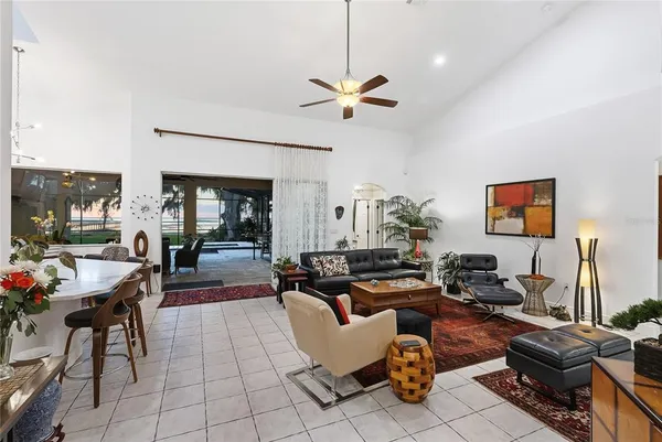 a living room with furniture a rug and a chandelier