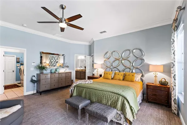 a bedroom with a bed and a chandelier