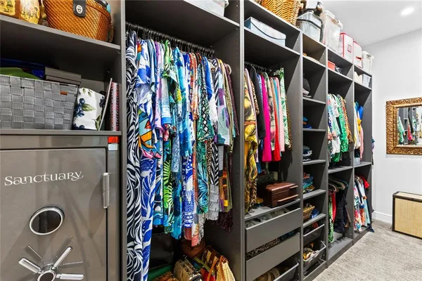 a view of walk in closet with clothes