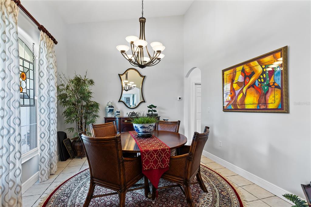 4846 Calasans Avenue St. Cloud, FL 34771 - Photo 22 of 61 a view of a dining room with furniture chandelier and wooden floor